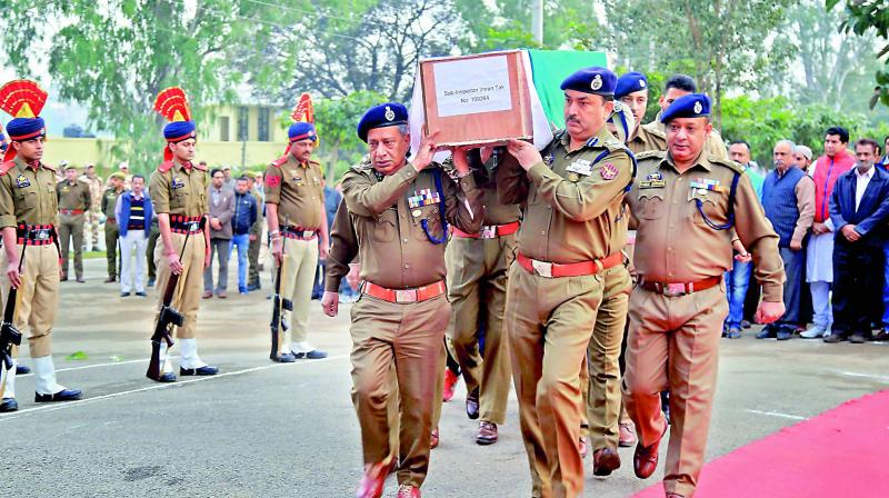 Police officials carry body of SI Imran Tak, who was killed in a militant attack, on Saturday. (Photo: PTI)