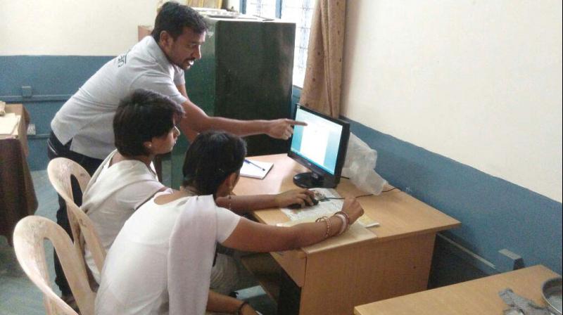 A Shikshan volunteers help government schoolchildren in the city learn computers and English.