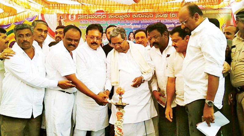 CM Siddaramaiah at a function to mark laying of foundation stone for Kanaka Bhavan at Nagamangala on Monday. MLAs Cheluvarayaswamy and Zameer Ahmed Khan are seen. (Photo: KPN)