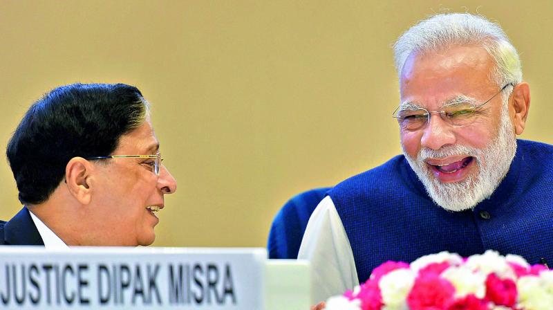 Prime Minister Narendra Modi with Chief Justice of India Justice Dipak Misra at valedictory session of the  National Law Day, 2017 function in New Delhi on Sunday. (Photo: PTI)