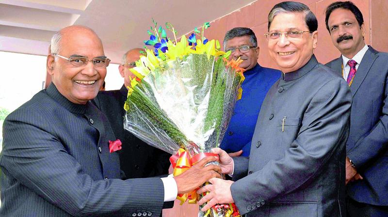 President Ram Nath Kovind being greeted by Chief Justice of India Justice Dipak Misra on Sunday. 	(Photo: PTI)