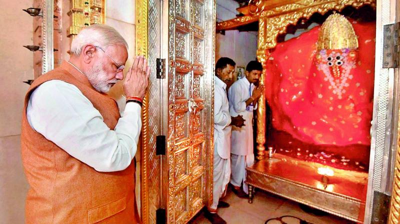 Prime Minister Narendra Modi during a visit to Ashapura Mata temple at Mata nou Madh before election campaign for the Assembly polls in Bhuj on Monday. (Photo: PTI)