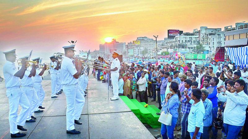 Navy personnel perform band as the sun sets down, during the rehearsals for the upcoming Navy Day celebrations on the sands of Ramakrishna Beach in Visakhapatnam on Friday. (Photo: DC)