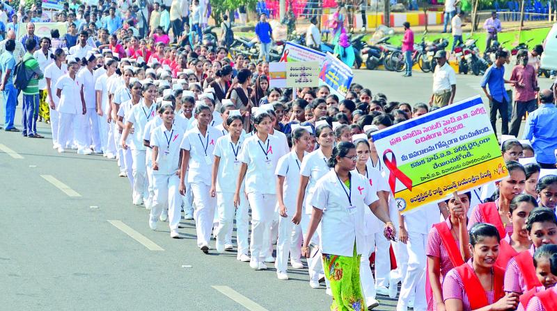 Students from various colleges take part in an awareness rally marking the World Aids Day near GVMC in Visakhapatnam on Friday. (Photo: DC)