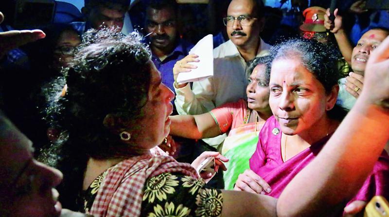 Union minister for defence, Nirmala Sitharaman with people affected by Cyclone Ockhi in the flood-hit Kanyakumari district in Tamil Nadu on Sunday. (Photo: PTI)