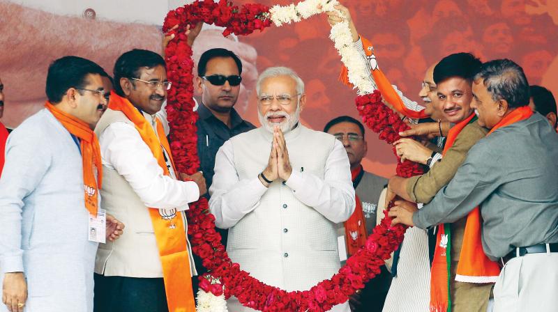 Prime Minister Narendra Modi receives a garland during an election campaign rally in Surendranagar on Sunday. (Photo: AP)