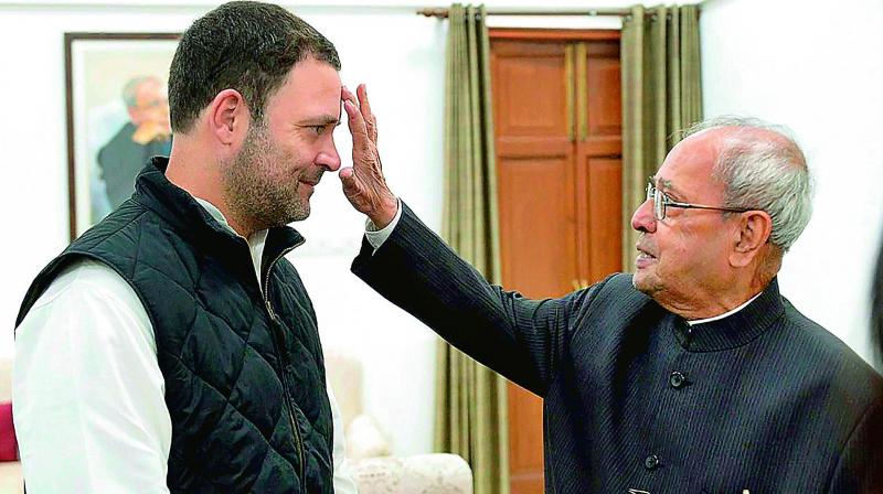 Congress vice-president Rahul Gandhi being greeted by former president Pranab Mukherjee before he filed his nomination papers for party presidents post, in New Delhi on Monday. (Photo: PTI)