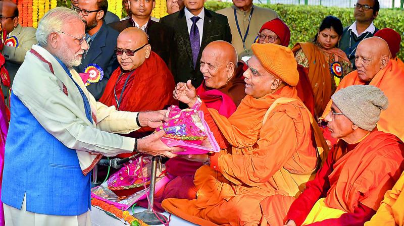 Prime Minister Narendra Modi presents gifts to Buddhist monks in New Delhi on Wednesday. (Photo: PTI)