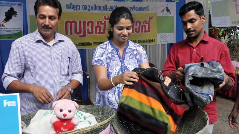 Officials display goods received at the Swap Shop on the premises of the Collectorate in Kozhikode on Wednesday.  (Photo: Venugopal)