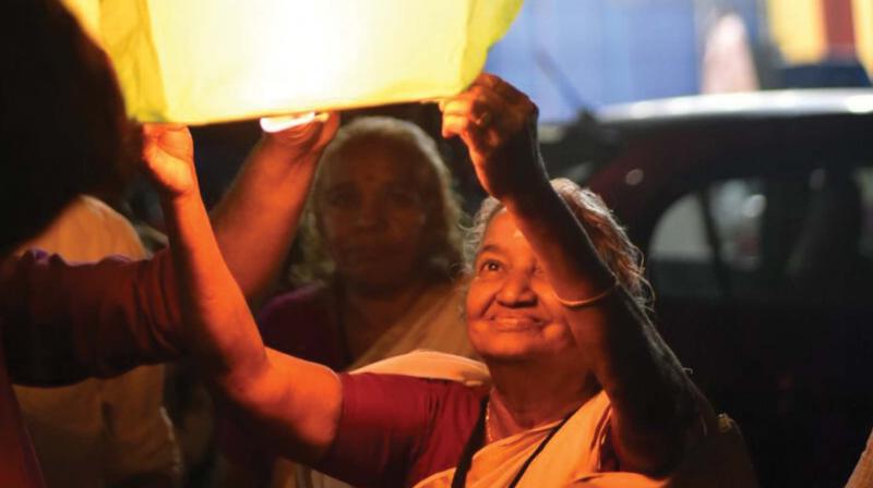 Elders release Chinese lantern to ring in the New Year at Puthuvype beach on Sunday.