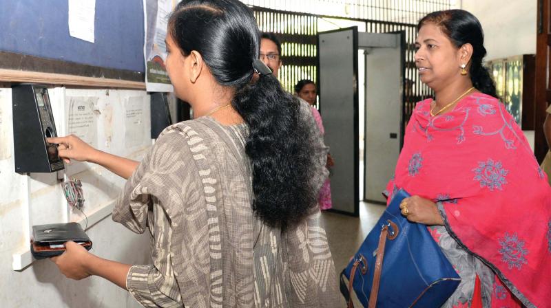 The employees are required to show the biometric card and then placing index finger on the machine.