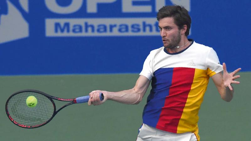 Frances Gilles Simon returns to Marin Cilic of Croatia in their Tata Open semifinal at the Balewadi Sports Complex in Pune on Friday. Simon won 1-6, 6-3, 6-2. (Photo: AFP)