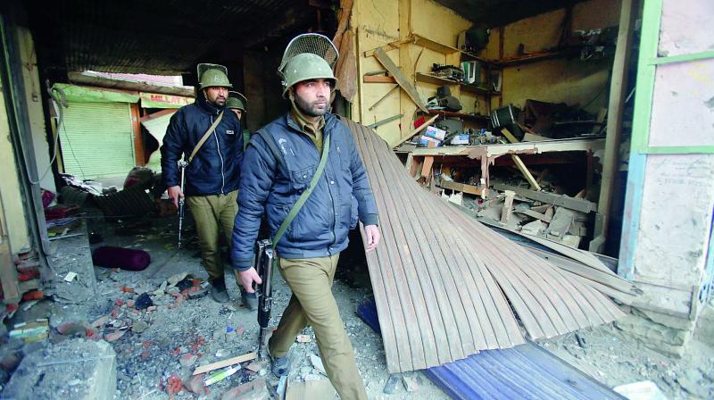 Policemen arrive to inspect the site of explosion in Sopore on Saturday. (Photo: AP)
