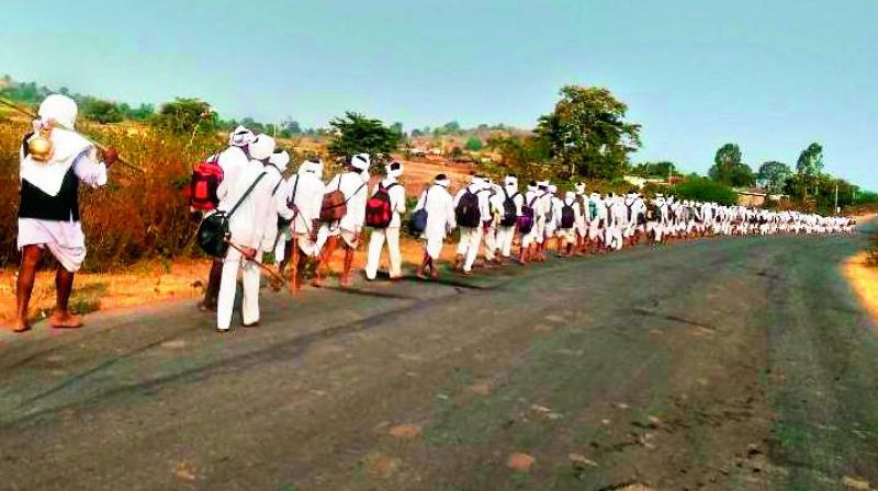 Adivasis of the Mesram clan return from the Nagoba temple in Indravelli mandal in Adilabad district after collecting water from the Godavari in Mancherial district.(Photo: DC)