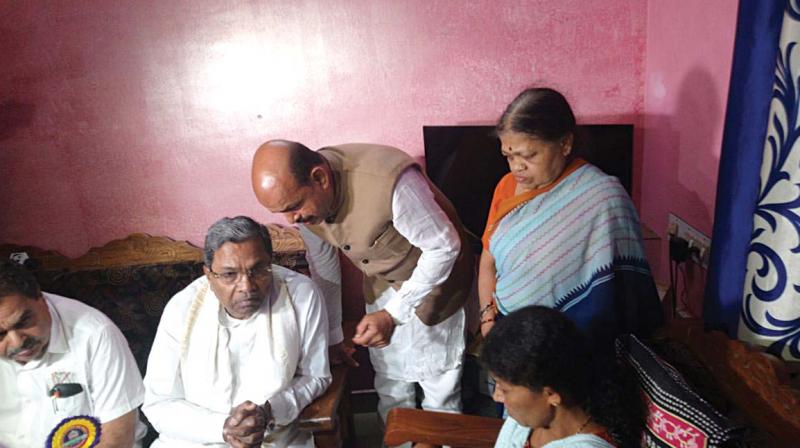 CM Siddaramaiah with Deepak Raos mother at her house in Mangaluru on Sunday. 	(Photo: KPN)