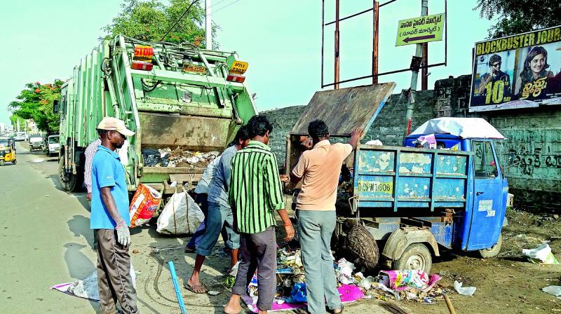 Sanitation workers remove garbage at Godown Road in Nizamabad on Sunday. (Photo: DC)