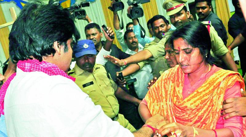 A woman ties a Raksha Kankanam to Jana Sena founder Pavan Kalyan during his visit to Karimnagar on Tuesday. (Photo: DC)