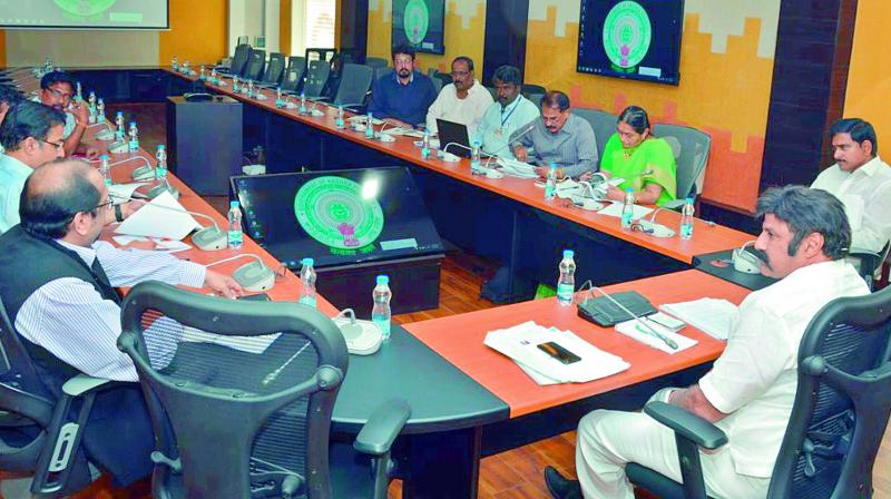 Actor-turned-politician and Hindupur MLA N. Balakrishna is sitting in CMs chair while conducting meeting with officials on Lepakshi festival at CMs camp office in Vijayawada on Wednesday. (Photo: PTI)