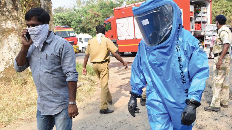 Fireman in protective suits walks near the site of an ammonia leak at Willingdon Island in Kochi on Saturday.  (Photo: DC)