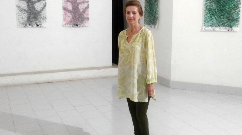 Constance Fulda with her tree paintings at Kerala Lilithakala Akademi, Thrissur. (Photo: DC)