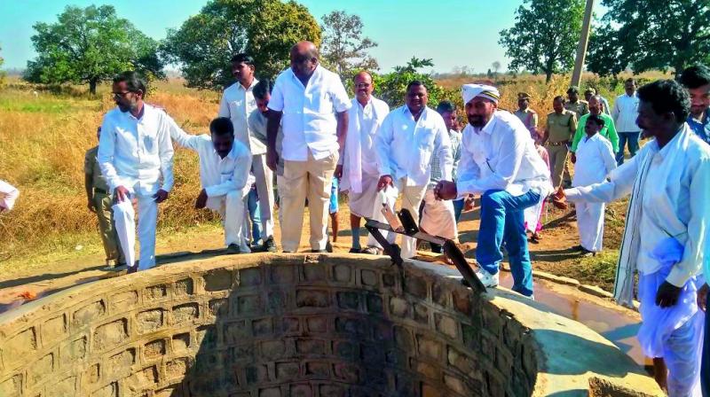 Minister Jogu Ramanna inspects drinking water well in Adilabad rural mandal on Friday. (Photo: DC)