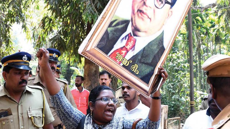 in no mood to quit until justice delivered: Arrested Dalit activists hold a protest at Puthencruz police station following a tensed situation at Vadayambadi near Kochi on Sunday. (Photo: DC)