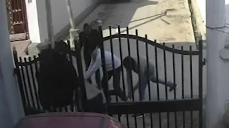 In the video, the victim identified as Abid Ali, a local journalist, is seen being attacked by half a dozen men at the gate of his house. (Photo: Screengrab)