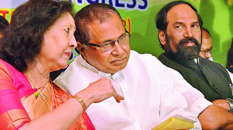 J. Geetha Reddy and K. Jana Reddy discuss while TPCC president N. Uttam Kumar Reddy looks on at the launch of six new chapters by All India Professionals Congress at a private hotel in city on Saturday. (Photo: DC)