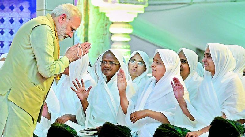 Prime Minister Narendra Modi greets saints at Bahubali Mahamasthakabhisheka Mahotsava at Shravanabelagola in Hassan on Monday. (Photo:  PTI)