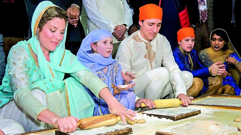 Canadian Prime Minister Justin Trudeau along with his family members makes chappattis during a visit to the Golden Temple in Amritsar on Wednesday. (Photo: PTI)