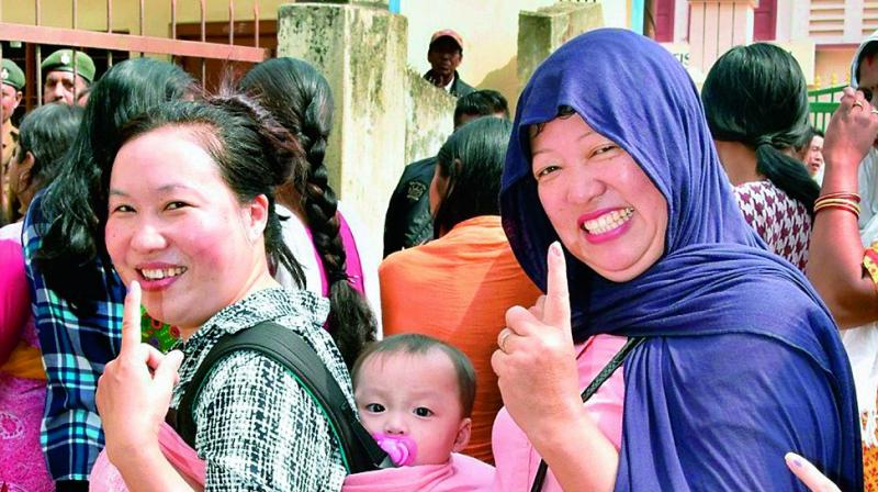 Women show their fingers marked with indelible ink after casting their votes during Nagaland Assembly elections, in Dimapur on Tuesday. (Photo: PTI)
