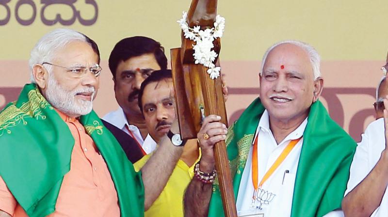 PM Narendra Modi and BJP state president B.S. Yeddyurappa at a party convention in Davanagere on Tuesday.