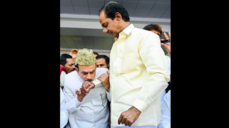 Dy CM Mahmood Ali kisses the hand of Chief Minister K. Chandra-sekhar during the public meeting addressed by Chief Minister K. Chandrasekhar Rao at Pragathi Bhavan in Hyderabad on Sunday. (Photo: DC)