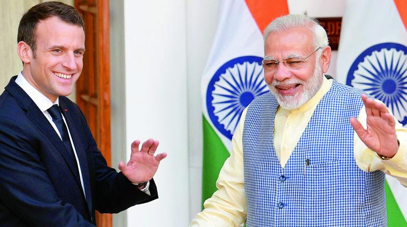 Prime Minister Narendra Modi with French President Emmanuel Macron in New Delhi on Saturday. (Photo: PTI)