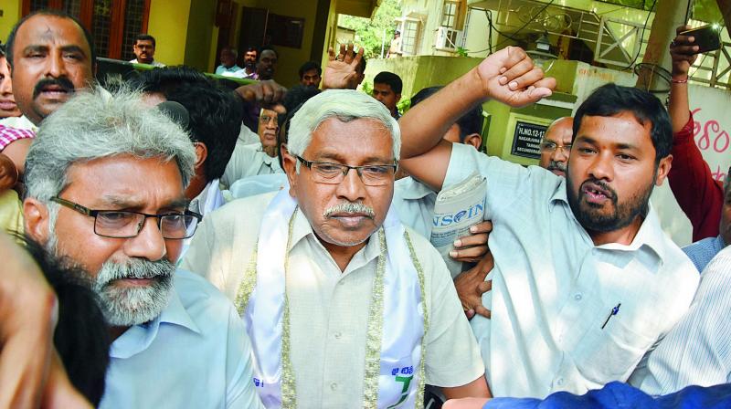 Supporters of TJAC president Professor K. Kodandaram shout slogans before he was arrested at his house on Saturday. (Photo: DC)