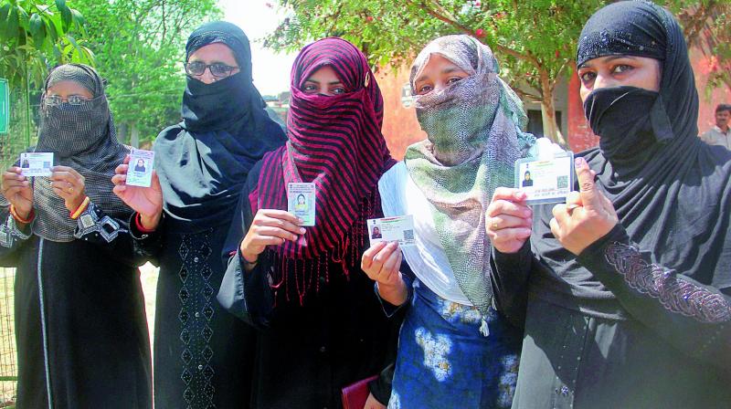 Women show their fingers marked with indelible ink during Phulpur Lok Sabha bypoll election at a polling center in Allahabad on Sunday. (Photo:  PTI)