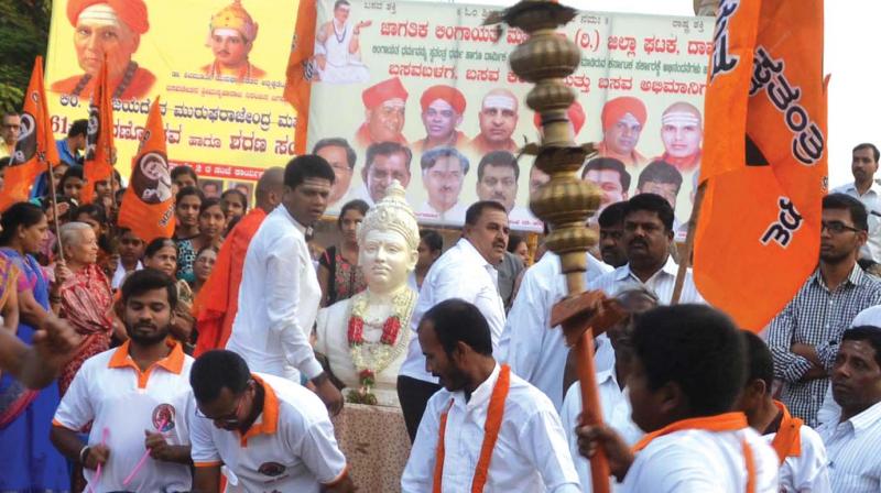 Lingayat Mahasabha members celebrate the Cabinet approval for separate religion tag for Lingayats in Davangere on Tuesday.