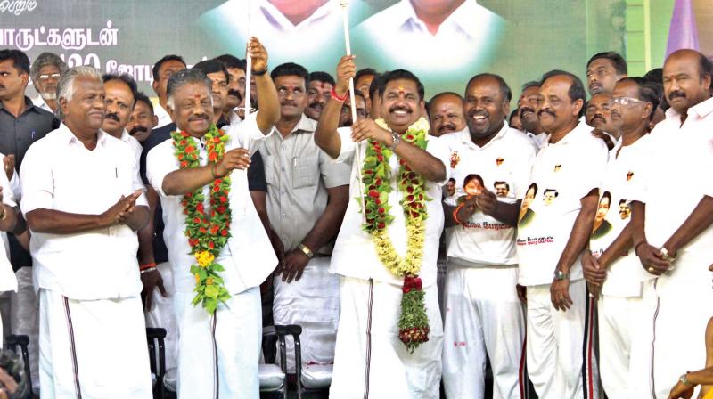 Chief Minister Edappadi K. Palaniswami and Deputy Chief Minister O. Panneerselvam presented with silver spears, during the marriage function of 120 couples, in Madurai, on Friday. (Photo: DC)