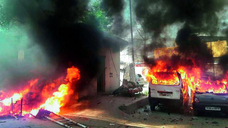 Vehicles set on fire by a group of protesters during Bharat Bandh call given by Dalit organisations in Meerut on Monday. (Photo: PTI)