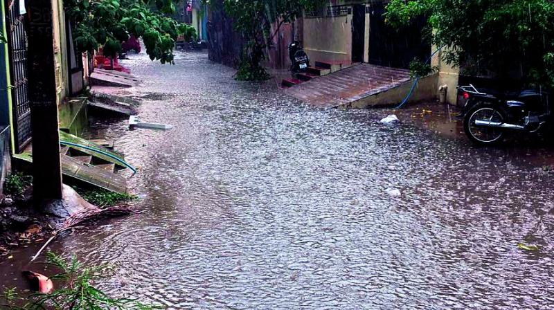 Mallikarjuna Nagar Road No 2 in Malkajgiri inundated due to over flowing drains and moderate rainfall.