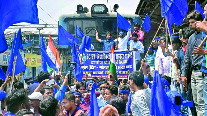 Bhim Army Sena members stop a train during Bharat Bandh call given by Dalit organisations against the alleged dilution of the Scheduled Castes and Scheduled Tribes act, in Patna. (Photo: PTI)