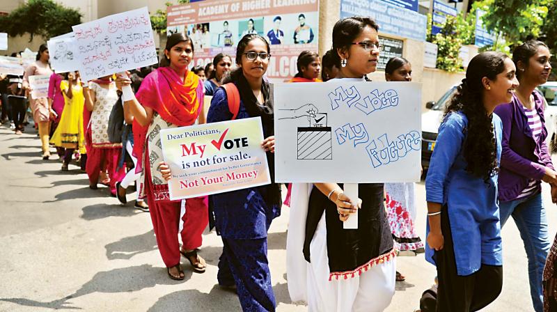 Students of Malleswaram Ladies Association College participate in a walkathon to educate people about the need to exercise their franchise, in Bengaluru on Friday. (Photo: DC)