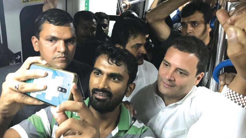 A fan takes a selfie with Congress president Rahul Gandhi in Metro, in Bengaluru on Sunday. (Photo: DC)