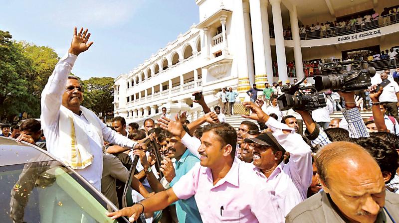 Chief Minister Siddaramaiah waves to his supporters after filing his nomination papers to contest from Chamundeshwari constituency in Mysuru on Friday. (Photo: PTI)