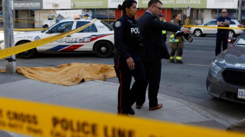 Toronto police investigates an incident where an van struck multiple people at a major intersection. (Reuters)