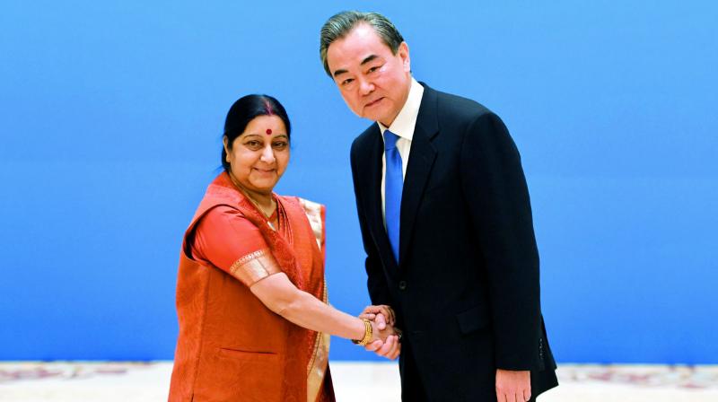 Foreign minister Sushma Swaraj greets her Chinese counterpart Wang Yi at the Diaoyutai State Guest House in Beijing on Tuesday. (Photo: AP)