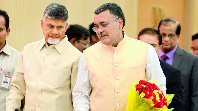 Chief Minister N. Chandrababu Naidu has a word with Chief secretary Dinesh Kumar on the first day of the collectors conference at Grievance Hall near Vijayawada on Tuesday. (Photo: DC)
