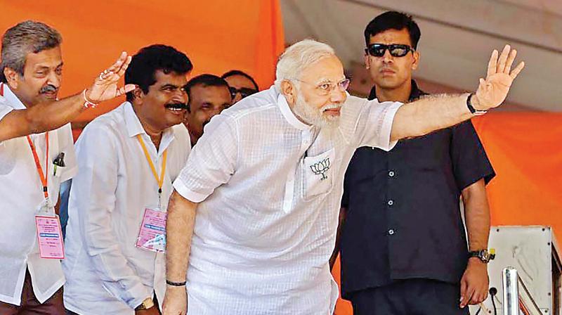 Prime Minister Narendra Modi waves at his supporters during an election rally in Chikkamagaluru on Wednesday. (Photo: PTI)