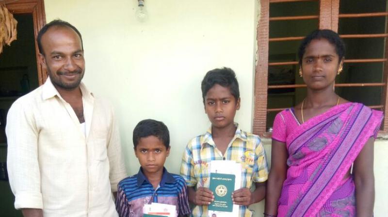 Nirmal (second from left) and Niranjan with investment subsidy cheques and pattadar passbooks along with their parents Naresh and Kavitha.