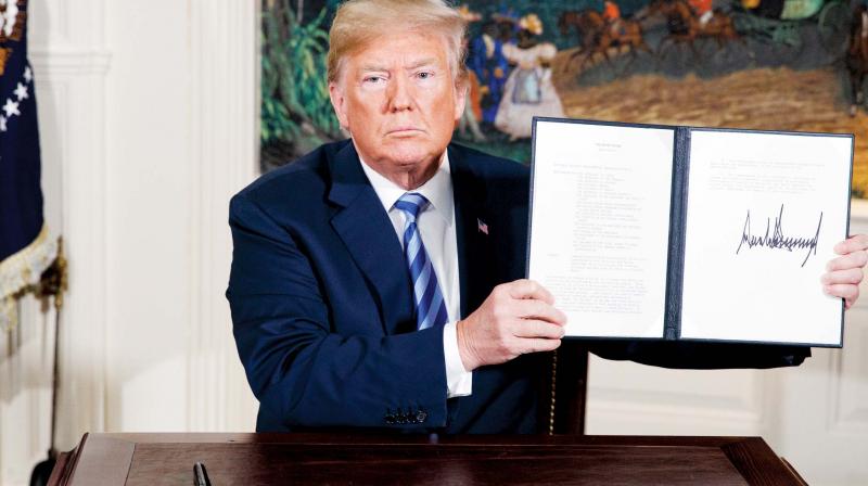 Donald Trump shows a signed Presidential Memorandum on the Iran nuclear deal on May 8 in Washington. (Photo: AP)